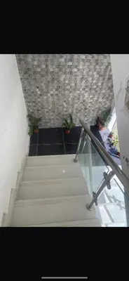 a stairway with a glass railing and some plants at The Garcias Village C with Jacuzzi ACNetflix in La Alianza