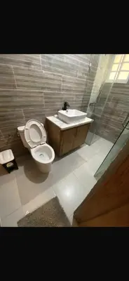a bathroom with a toilet and a sink at The Garcias Village C with Jacuzzi ACNetflix in La Alianza
