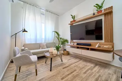 a living room with a couch and a tv at Cana Brava Residences Rental Apartment Punta Cana in Punta Cana