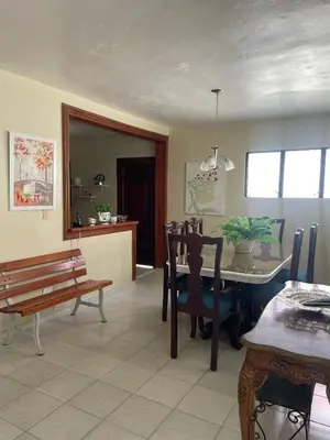 a living room with a table and chairs and a bench at Your best escape in Dominican Republic!! in Santiago de los Caballeros