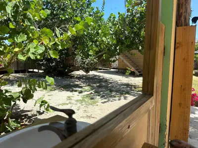 an open door with a view of a yard at Buen Hombre Kite School with Accommodations in La Costa de Buen Hombre