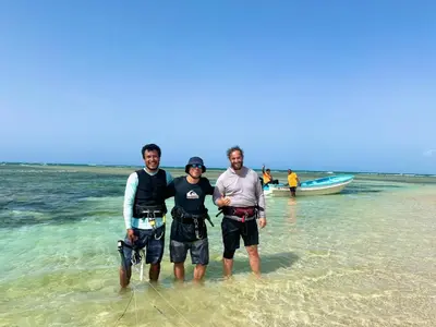three men standing in the water on the beach at Buen Hombre Kite School with Accommodations in La Costa de Buen Hombre