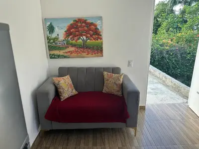 a couch in a room with a painting on the wall at Damaris Bed & Breakfast in Las Terrenas