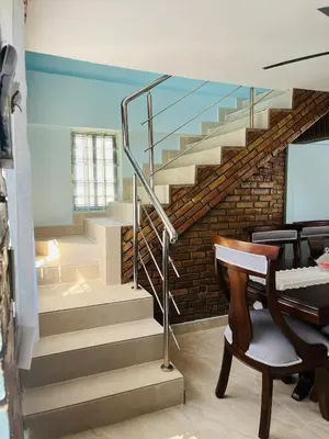 a staircase in a room with a table and a piano at Villa Rosa Bella Perfect for families or groups in Palmar de Ocoa