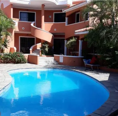 a swimming pool in front of a house at Residence Oasis BocachiCa in Boca Chica