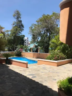 a swimming pool in the middle of a yard at Residence Oasis BocachiCa in Boca Chica