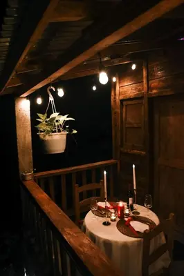 a table with candles and a potted plant on a balcony at Cabañas en las Montañas in San Cristóbal