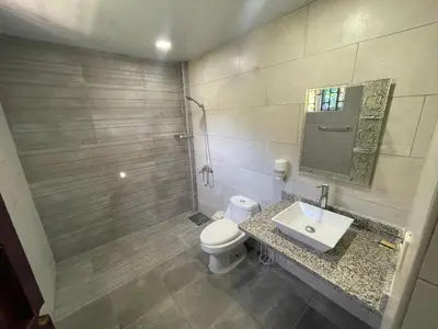 a bathroom with a toilet and a sink and a mirror at La Cigua in Pedro Brand