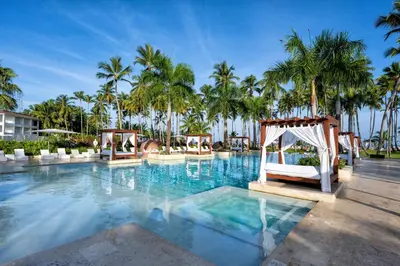 a pool at the resort with a gazebo and palm trees at Viva V Samana by Wyndham, A Trademark Adults All Inclusive in Las Terrenas