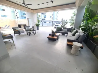 a living room with couches and tables and plants at Lujoso exclusivo próximo monumento in Santiago de los Caballeros