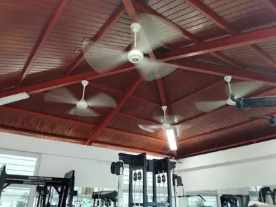 two ceiling fans are hanging from the ceiling of a gym at Apartment in Harmony I in Santiago de los Caballeros
