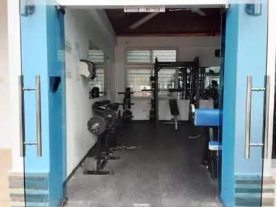 a gym with several treadmills and machines at Apartment in Harmony I in Santiago de los Caballeros