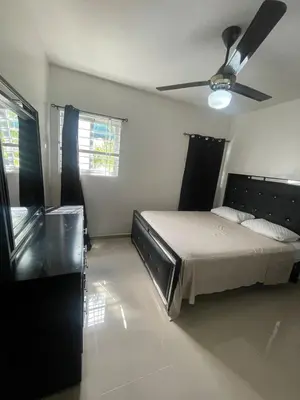 a bedroom with a bed and a ceiling fan at Apartment in Harmony I in Santiago de los Caballeros