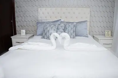 two swans made out of towels on a bed at Beautiful condo in La Vega in Concepción de La Vega