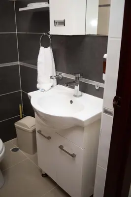 a bathroom with a white sink and a toilet at Beautiful condo in La Vega in Concepción de La Vega
