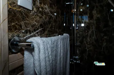 a bathroom with a towel hanging from a shower at Villasol Pedernales in Pedernales