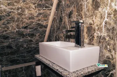 a white sink in a bathroom with a black fountain at Villasol Pedernales in Pedernales