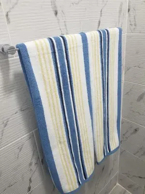 a towel hanging on a towel rack in a bathroom at Vamar Apartamentos in San Felipe de Puerto Plata