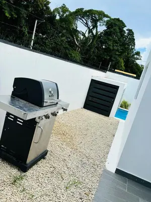 a grill and a toaster sitting on a patio at El Rincon Soleado in San Felipe de Puerto Plata
