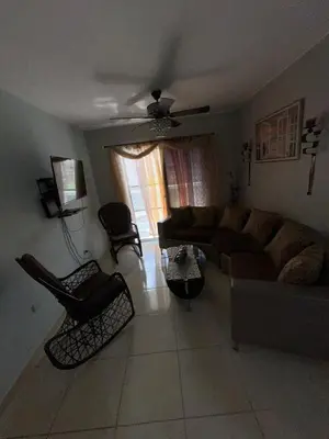 a living room with a couch and chairs at La Romana Caleta Apartment in La Romana