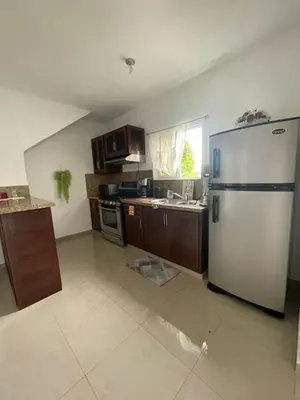 a kitchen with a stainless steel refrigerator in a room at Apartamento acogedor a 5 minutos de la playa in San Felipe de Puerto Plata