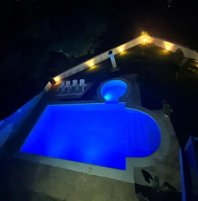 a blue swimming pool at night with lights at Itzayana 1 in Las Terrenas
