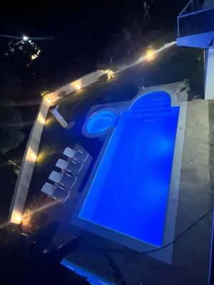 a blue sign on the side of a building at night at Itzayana 1 in Las Terrenas