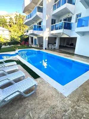 a villa with a swimming pool in front of a building at Itzayana 1 in Las Terrenas