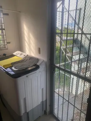 a room with a heater and a door with a window at Cozy, comfortable three-bedroom condo in Santiago,DR in Santiago de los Caballeros