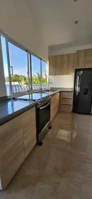 a kitchen with a stove and a refrigerator at Villa Jardín Tropical 2 in Las Galeras