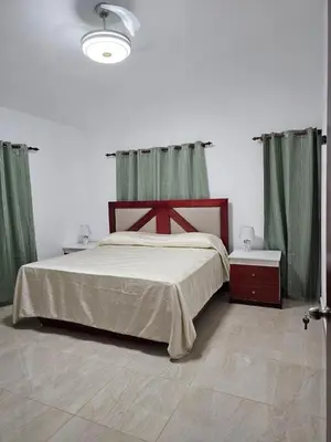 a bedroom with a large bed with green curtains at Villa Jardín Tropical 2 in Las Galeras