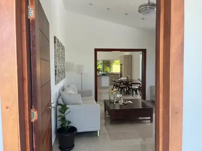 a living room with a white couch and a table at Villa Jardín Tropical 2 in Las Galeras
