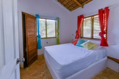 a bedroom with a bed and two windows at Paradiso del Caribe Apartments A1 and A2, Your Perfect Stay in Las Galeras in Las Galeras