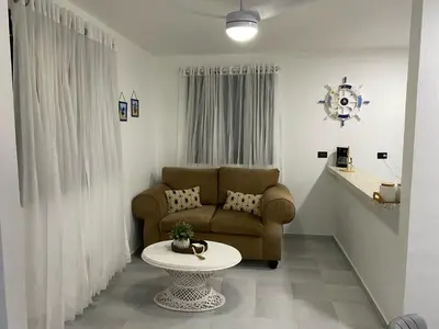 a living room with a couch and a table at Apartamento en el Batey de Sosua in Sosúa