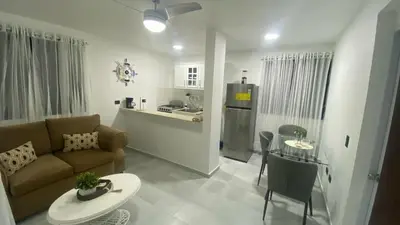 a living room with a couch and a table at Apartamento en el Batey de Sosua in Sosúa
