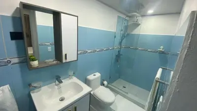 a bathroom with a sink and a toilet and a mirror at Apartamento en el Batey de Sosua in Sosúa