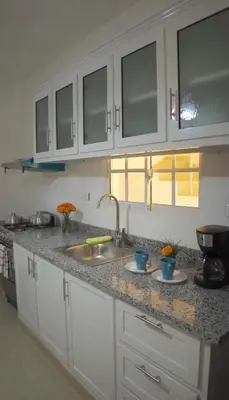 a kitchen with a sink and a counter top at Elida Oceanfront Rentals in Sampiño