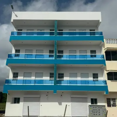 an apartment building with blue balconies at Elida Oceanfront Rentals in Sampiño