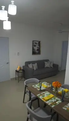 a living room with a couch and a table at Elida Oceanfront Rentals in Sampiño