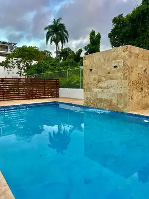 a large swimming pool with blue water at GH Condos by Sunrise3 in Puerto Plata