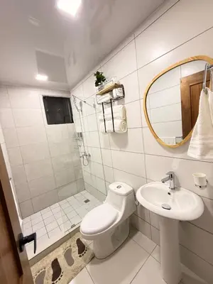 a bathroom with a toilet and a sink and a mirror at GH Condos by Sunrise1 in San Felipe de Puerto Plata