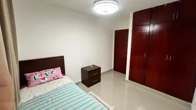 a bedroom with a bed with a pink pillow at AP Filathefia 01 in San Isidro