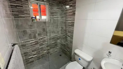 a bathroom with a toilet and a sink at AP Filathefia 01 in San Isidro