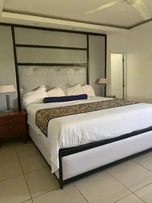 a bedroom with a large bed with a large headboard at VILLAS SONJASAA LOFt in Baní