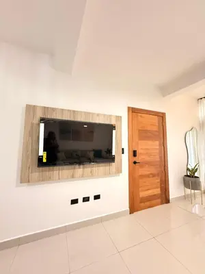a living room with a flat screen tv on a wall at GH Condos by Sunrise2 in San Felipe de Puerto Plata