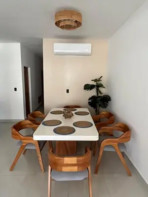 a dining room with a white table and chairs at GH Condos by Sunrise2 in San Felipe de Puerto Plata
