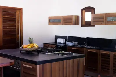 a kitchen with a bowl of fruit on a counter at Penthouse beach front in Las Terrenas
