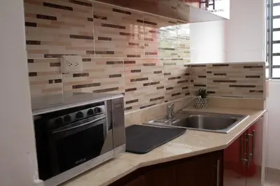 a kitchen with a sink and a stove at Apartamento tranquilo y cómodo in La Javilla