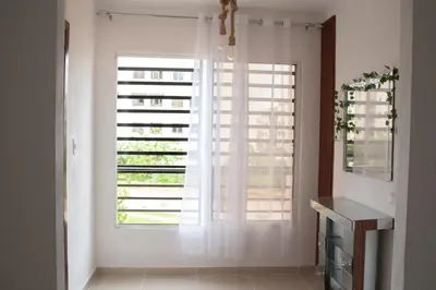 a large window with white curtains in a room at Apartamento tranquilo y cómodo in La Javilla