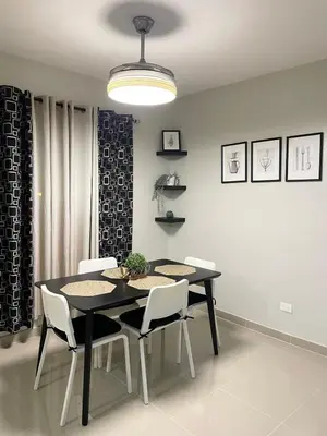 a dining room with a black table and white chairs at 3 bedroom apartment with private jacuzzi and terrace in Ensanche Savica de Mendoza